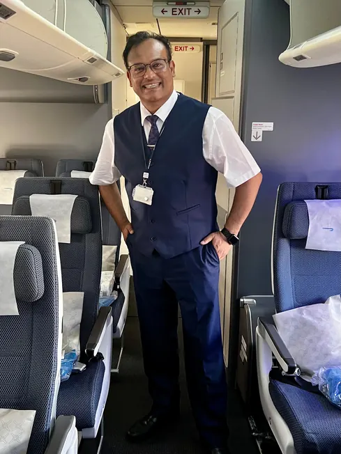 Sabbir Karim in uniform standing in an aircraft cabin