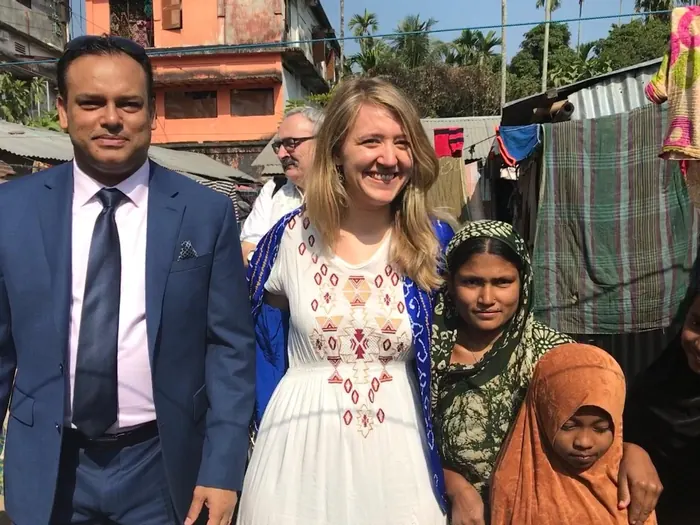 Sabbir Karim with a visitor and local families in Bangladesh